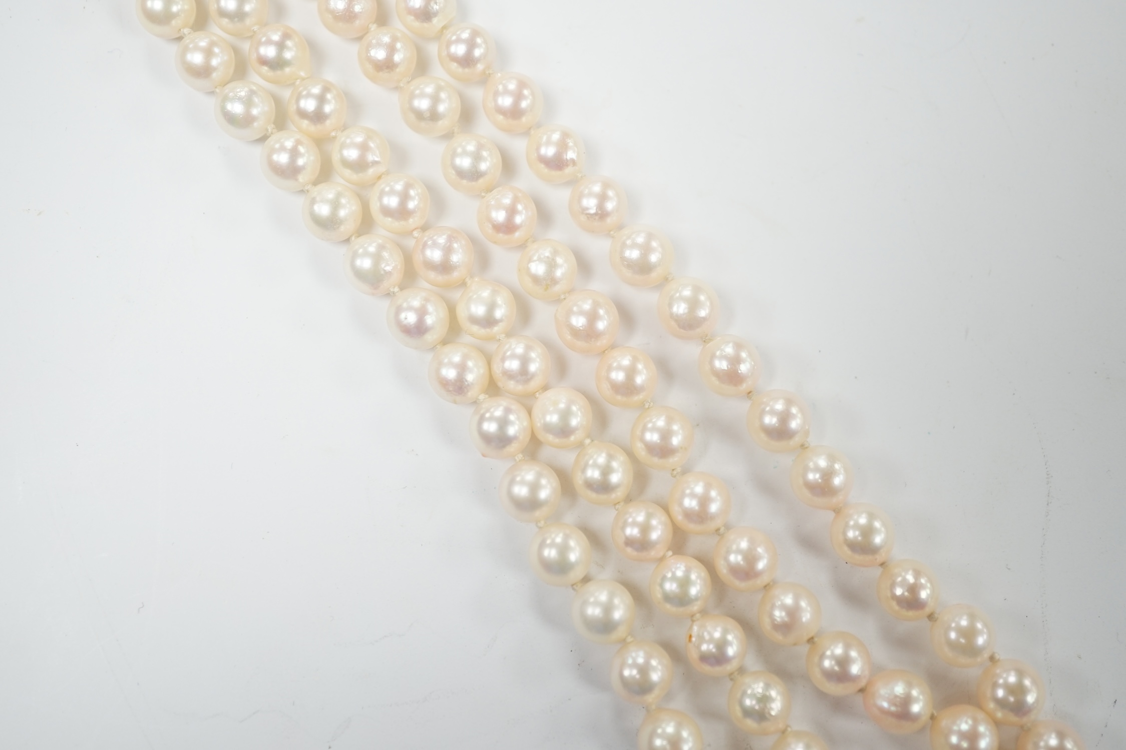 A double strand cultured pearl necklace, with cabochon sapphire and diamond chip cluster set 14k clasp, 44cm. Condition - good